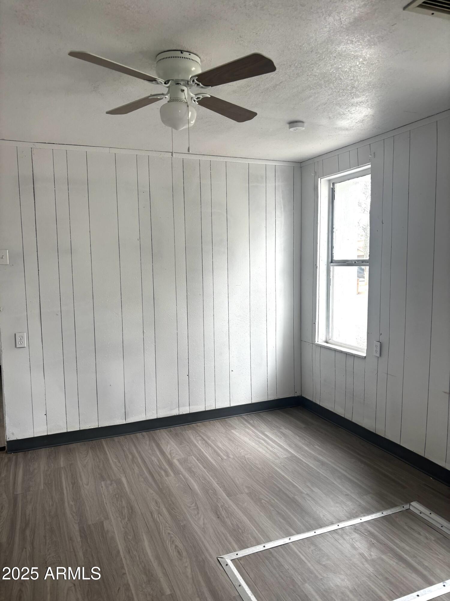 398 E Avenue Douglas, AZ 85607 - Photo 6 of 11 a view of a livingroom with wooden floor and a window