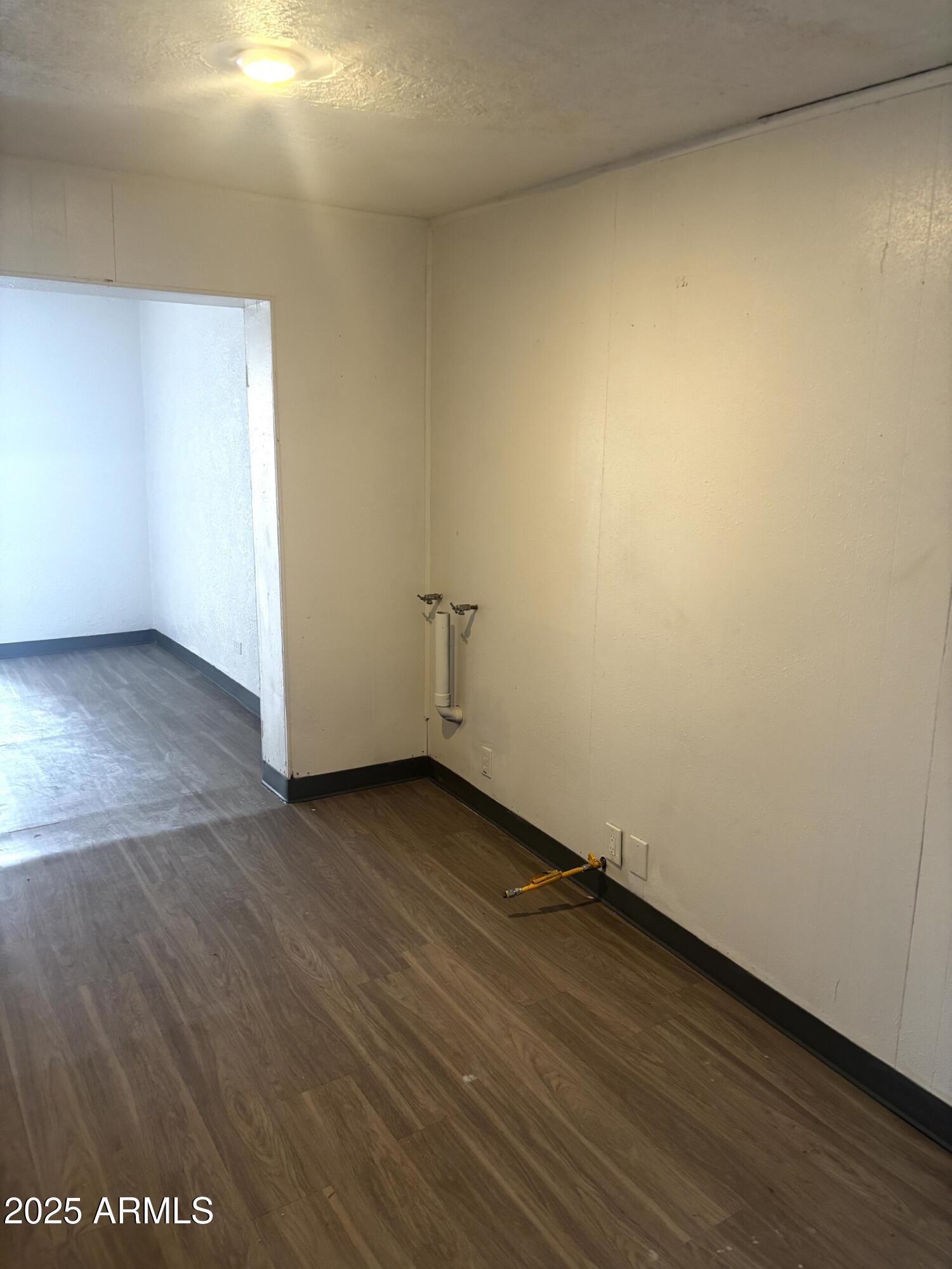 398 E Avenue Douglas, AZ 85607 - Photo 9 of 11 an empty room with wooden floor