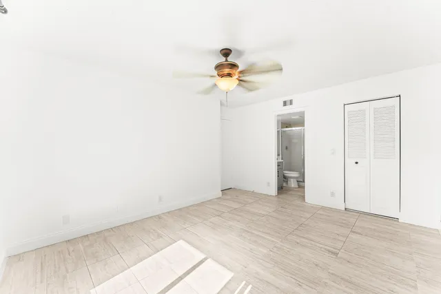 a view of a room with a sink and chandelier fan