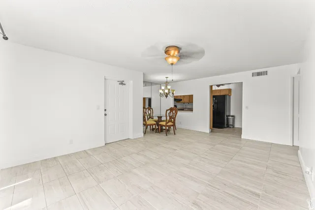 a view of empty room with a fireplace and a window