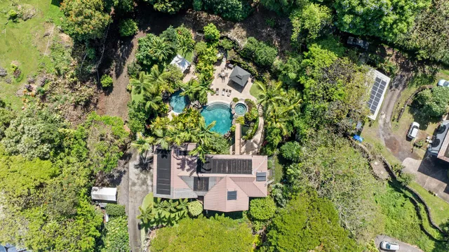 an aerial view of a house with a yard and garden