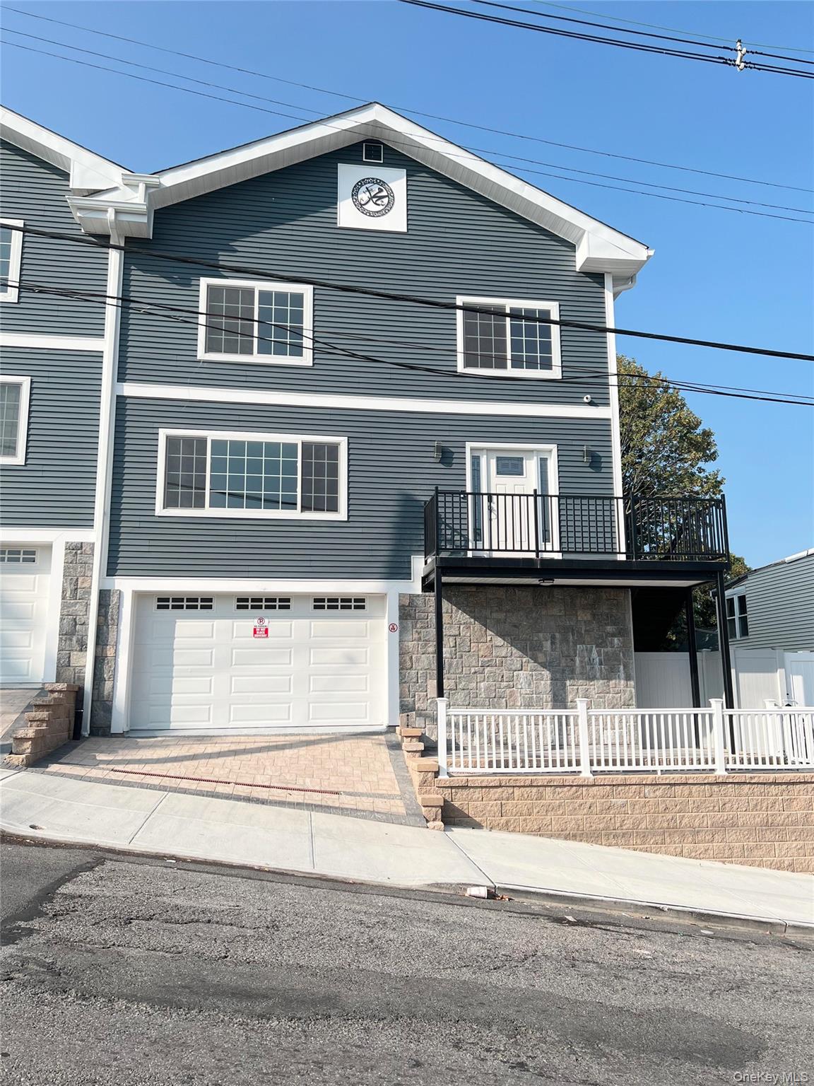 a front view of a house with a street