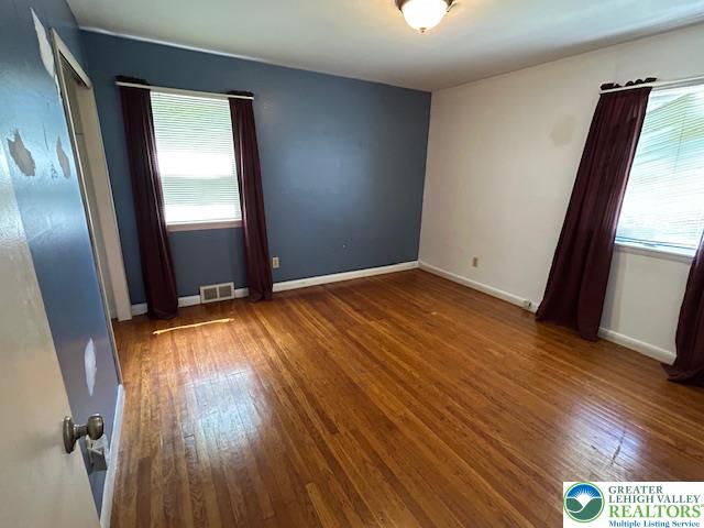 2065 Hopewell Road Bethlehem, PA 18017 - Photo 11 of 19 Sun-kissed hardwood floors and a vibrant accent wall create a welcoming atmosphere in this spacious bedroom with a large, walk-in closet.