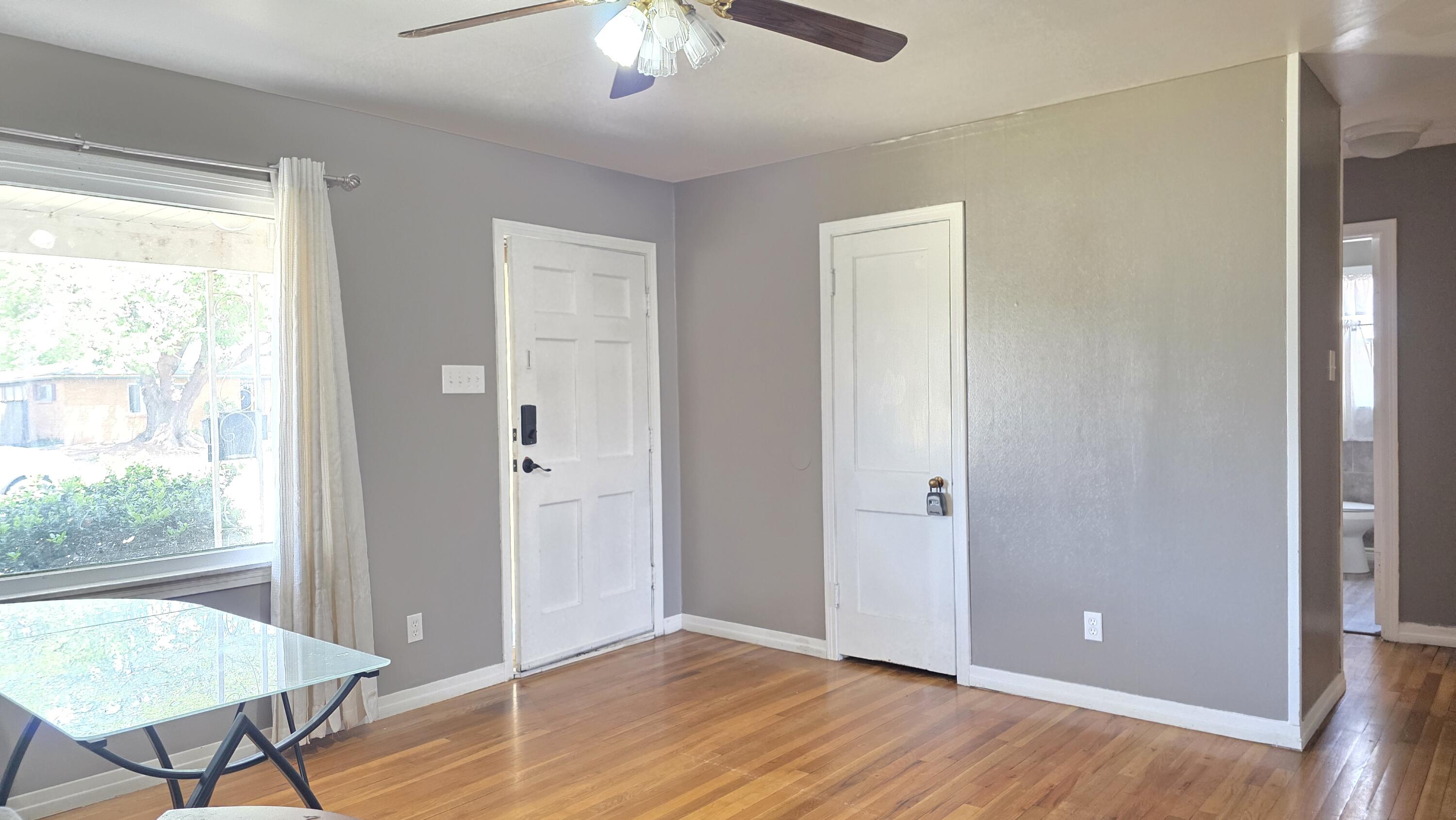 2403 38th Street Lubbock, TX 79412 - Photo 2 of 17 a view of a hallway with wooden floor and a livingroom