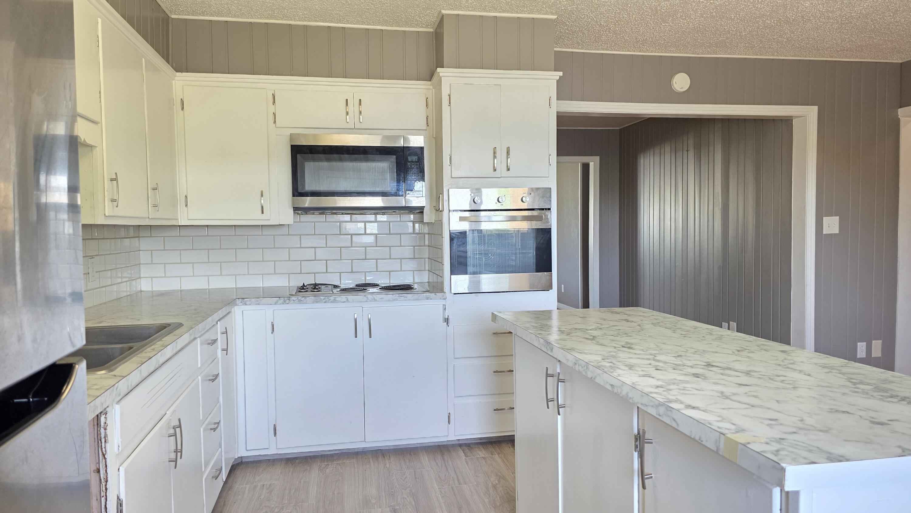2403 38th Street Lubbock, TX 79412 - Photo 6 of 17 a kitchen with stainless steel appliances granite countertop a sink and cabinets
