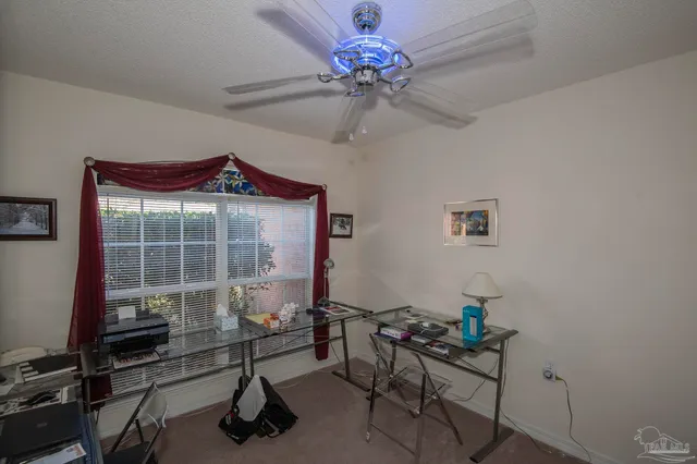 a work room with furniture and a potted plant