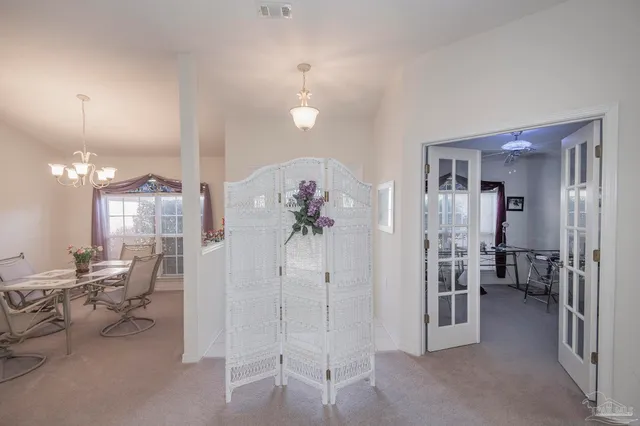 a view of a livingroom with furniture and a chandelier
