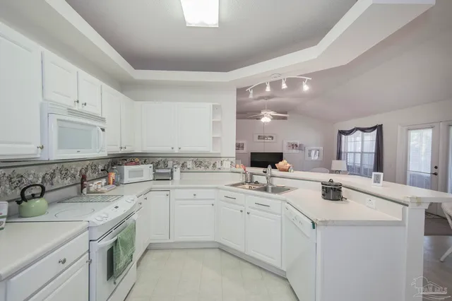 a kitchen that has a sink and a stove in it