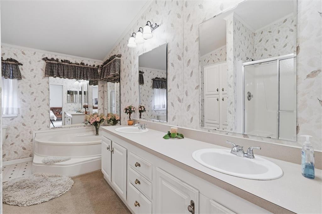 2001 Pond Lane Elizabeth, PA 15037 - Photo 22 of 38 a spacious bathroom with double vanity sinks a toilet a mirror and shower