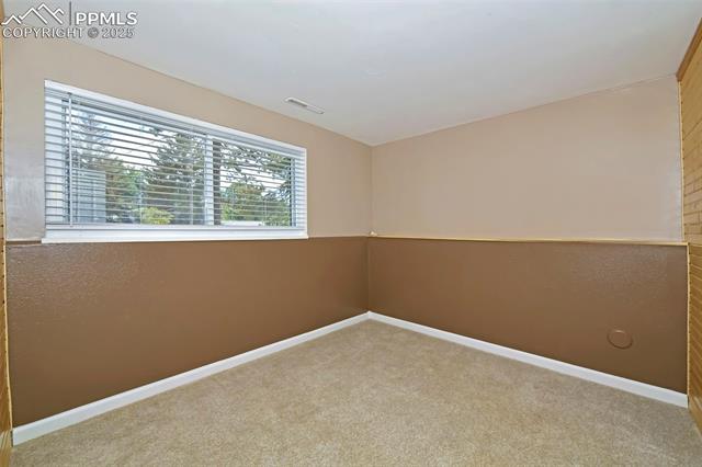 1914 Wooten Road Colorado Springs, CO 80915 - Photo 27 of 39 Carpeted empty room featuring baseboards