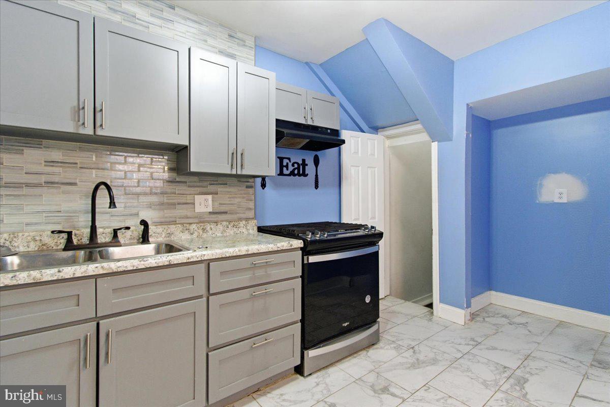 206 36th Street Southeast Washington, DC 20019 - Photo 13 of 28 a kitchen with stainless steel appliances granite countertop a sink stove and refrigerator
