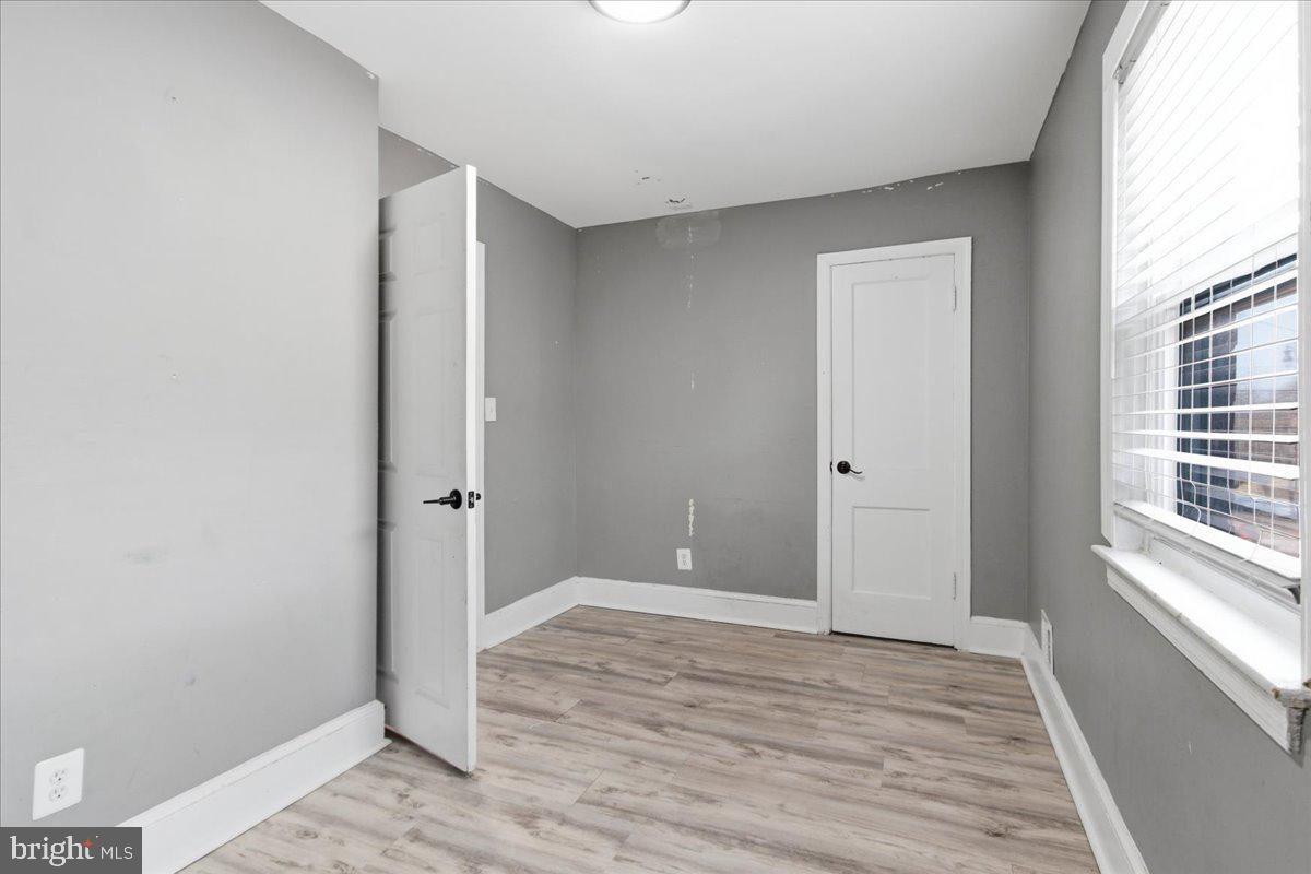 206 36th Street Southeast Washington, DC 20019 - Photo 14 of 28 a view of an empty room with wooden floor and a window