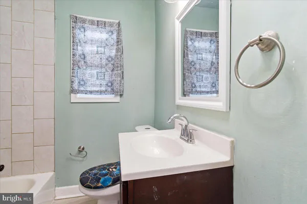 a bathroom with a sink a toilet and a mirror