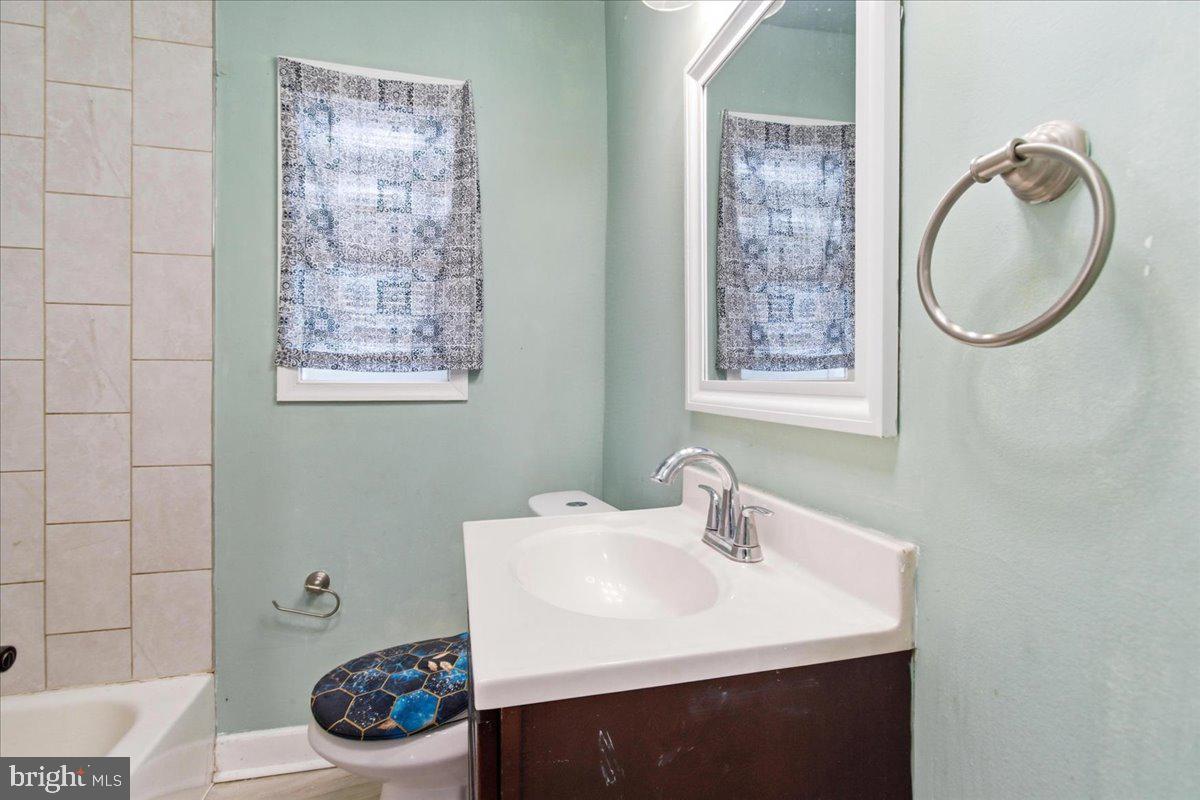 206 36th Street Southeast Washington, DC 20019 - Photo 16 of 28 a bathroom with a sink a toilet and a mirror
