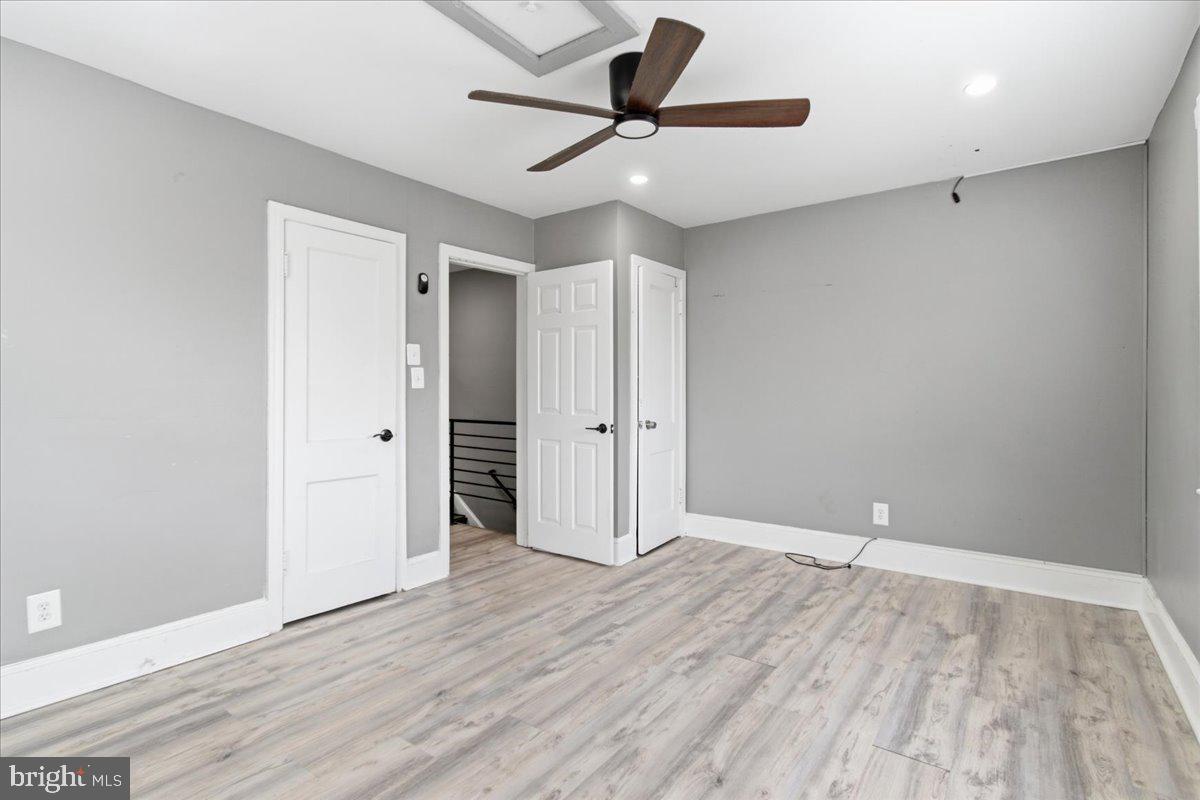 206 36th Street Southeast Washington, DC 20019 - Photo 18 of 28 an empty room with wooden floor and a ceiling fan
