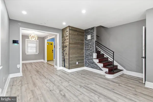 a view of an empty room with stairs and ventilation