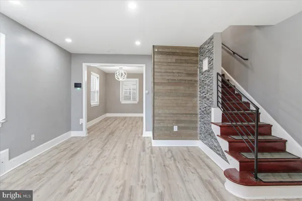 a view of entryway with wooden floor and stairs