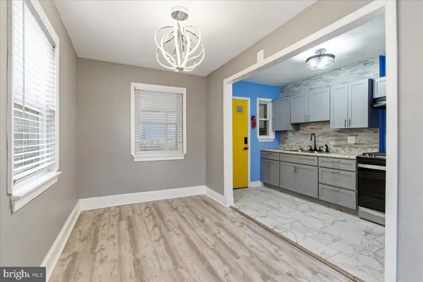 a kitchen with a refrigerator a stove a sink and cabinets
