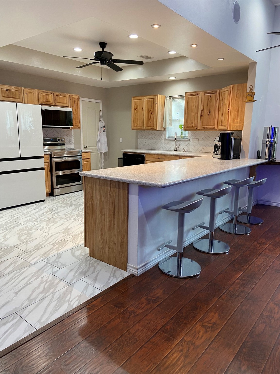 195 Rim Rock Road Onalaska, TX 77360 - Photo 4 of 45 a kitchen with stainless steel appliances kitchen island granite countertop a table chairs sink and cabinets