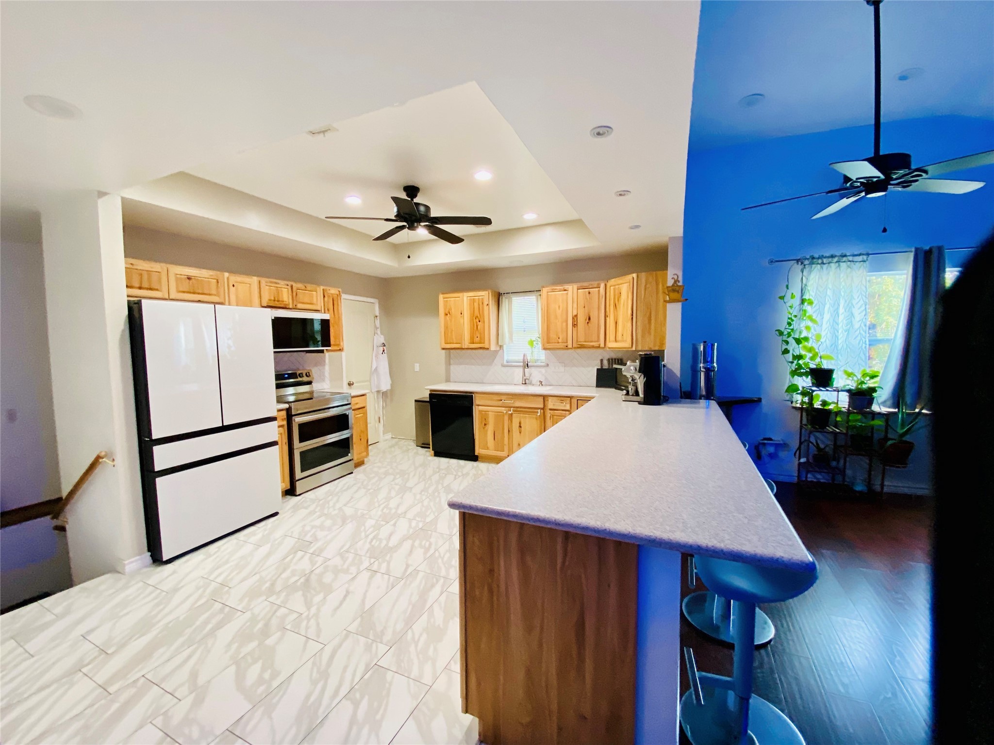 195 Rim Rock Road Onalaska, TX 77360 - Photo 5 of 45 a kitchen with stainless steel appliances kitchen island a white cabinets and a chandelier