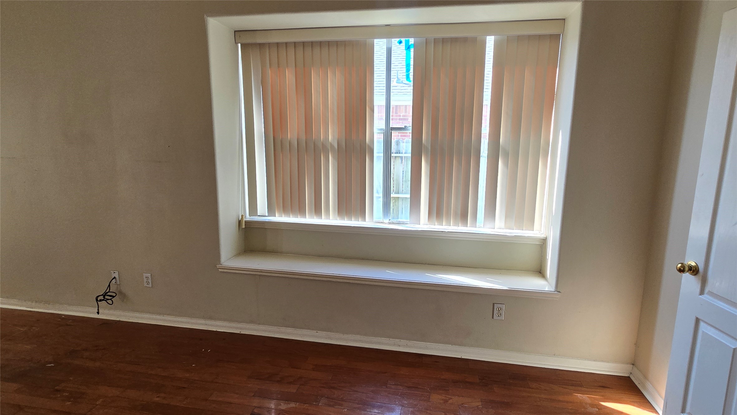 131 Annes Way Stafford, TX 77477 - Photo 12 of 25 a view of an empty room with wooden floor and a window
