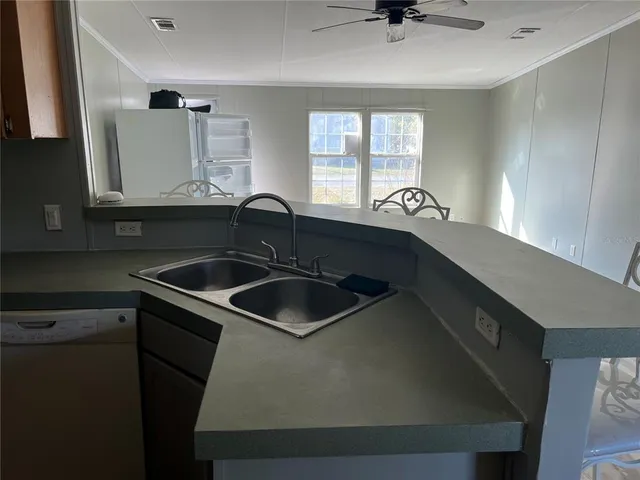a kitchen with a sink cabinets and window