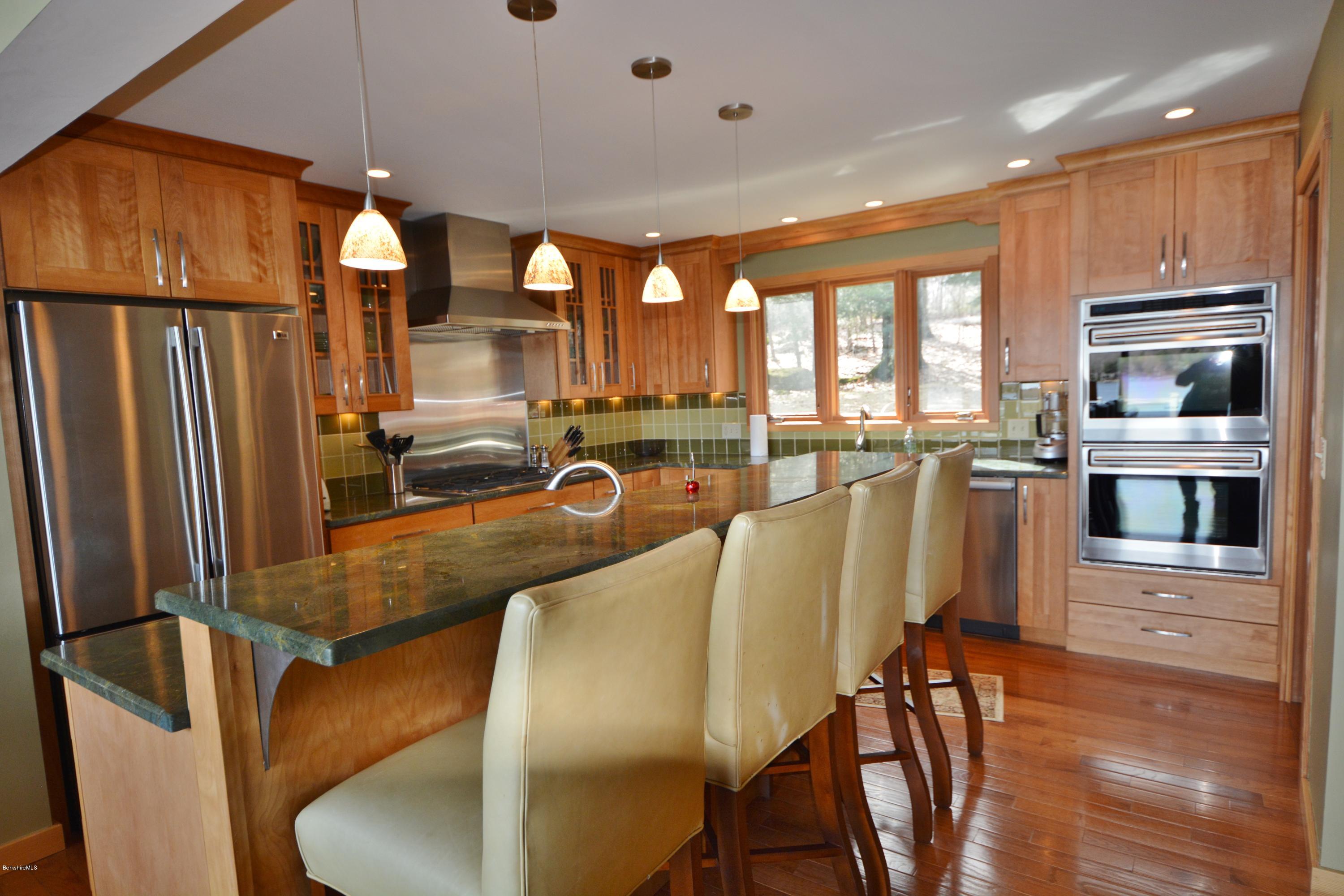 408 Pine Road Otis, MA 01029 - Photo 14 of 35 a living room with stainless steel appliances furniture wooden floor and a kitchen view