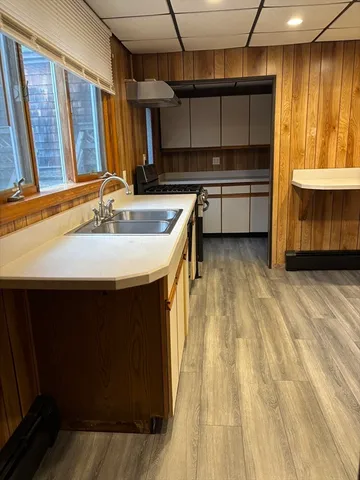 a kitchen with stainless steel appliances a sink stove and cabinets