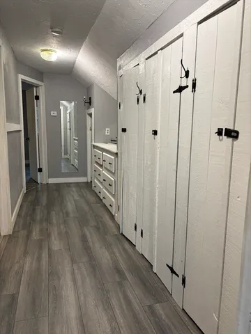 a view of a hallway with wooden floor