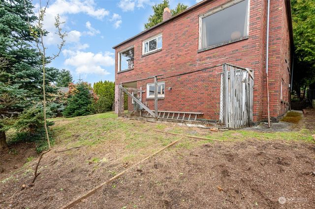 a view of a wooden fence next to a yard