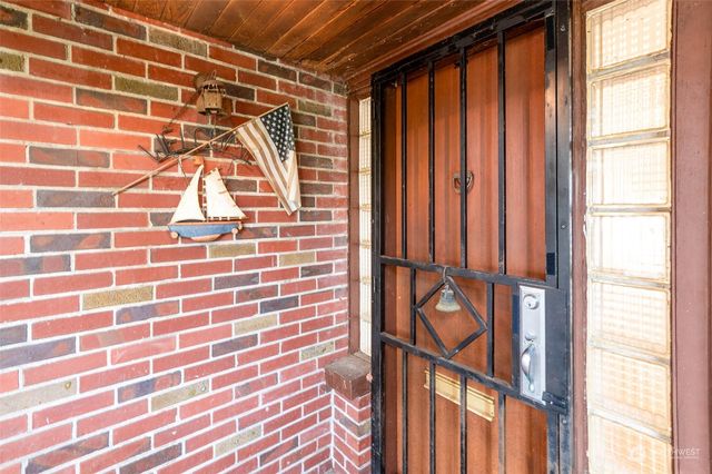 a view of empty room with wooden floor and fireplace