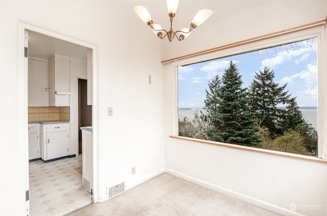 a view of a kitchen with refrigerator and a stove