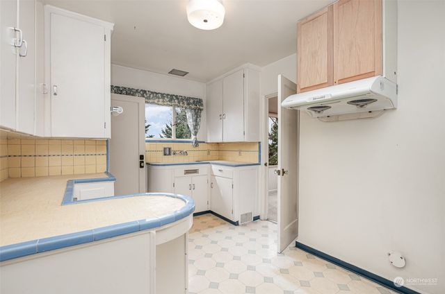 a utility room with cabinets washer and dryer