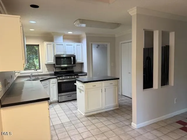 a kitchen with stainless steel appliances granite countertop a refrigerator and a stove