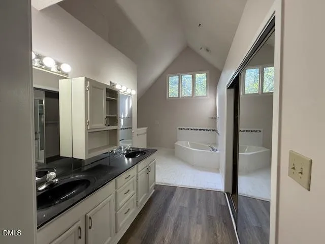 a kitchen with refrigerator and cabinets
