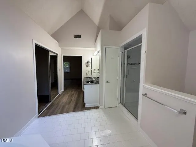 a view of a hallway with wooden shelves