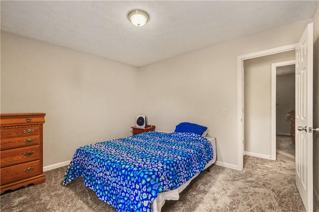 280 Courtyard Circle Winder, GA 30680 - Photo 11 of 24 a bed room with a bed and a dresser