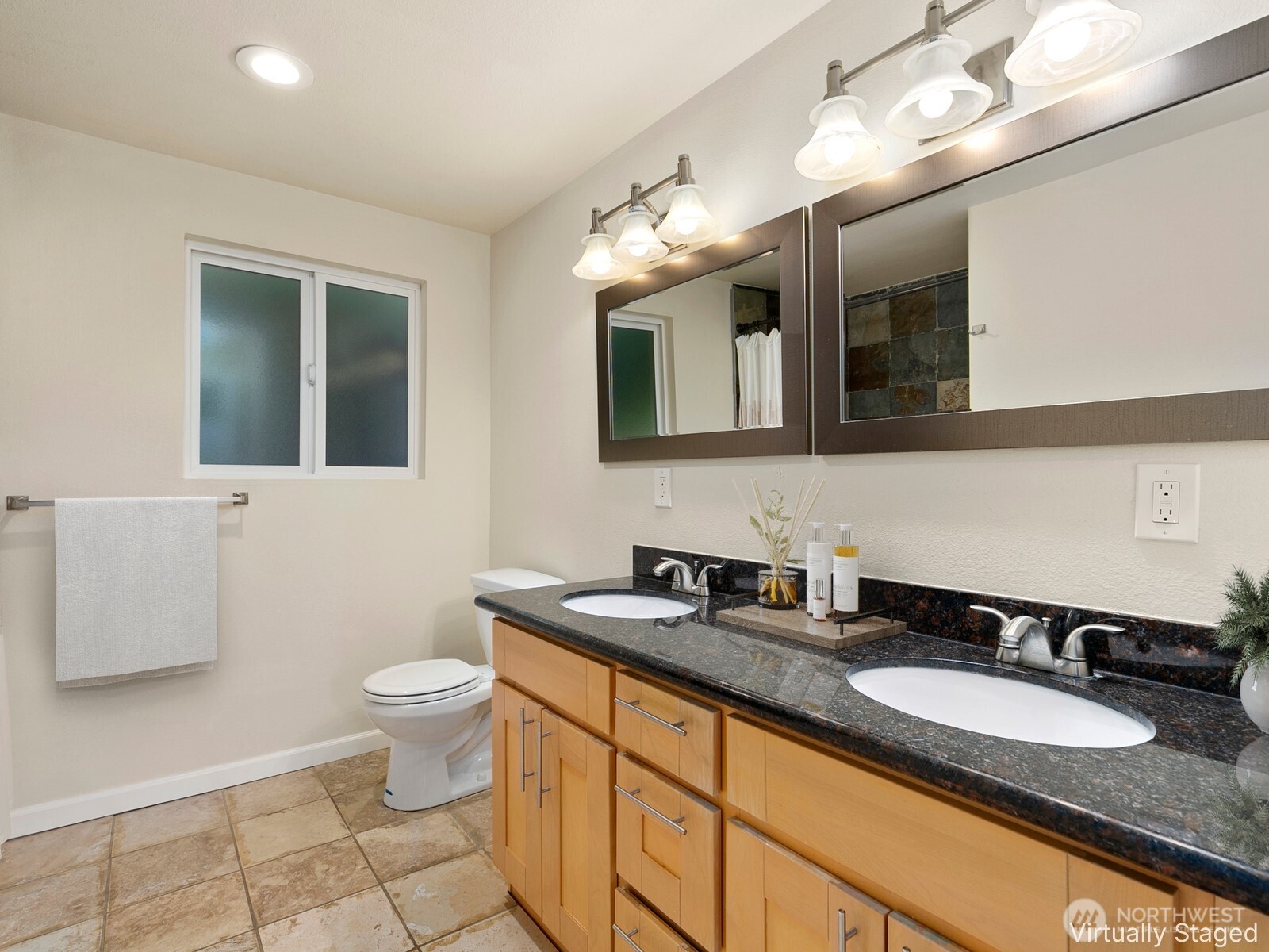 3701 Southwest Southern Street Seattle, WA 98126 - Photo 15 of 33 a bathroom with a granite countertop sink a toilet and mirror