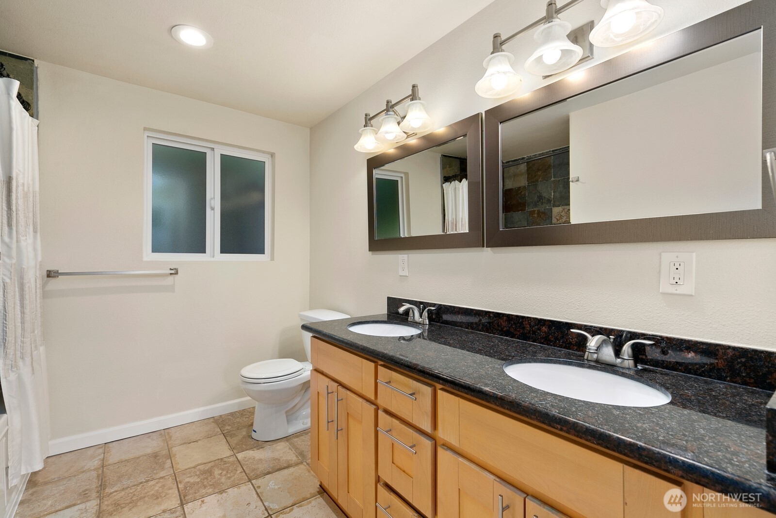 3701 Southwest Southern Street Seattle, WA 98126 - Photo 16 of 33 a bathroom with a granite countertop sink a toilet and a mirror