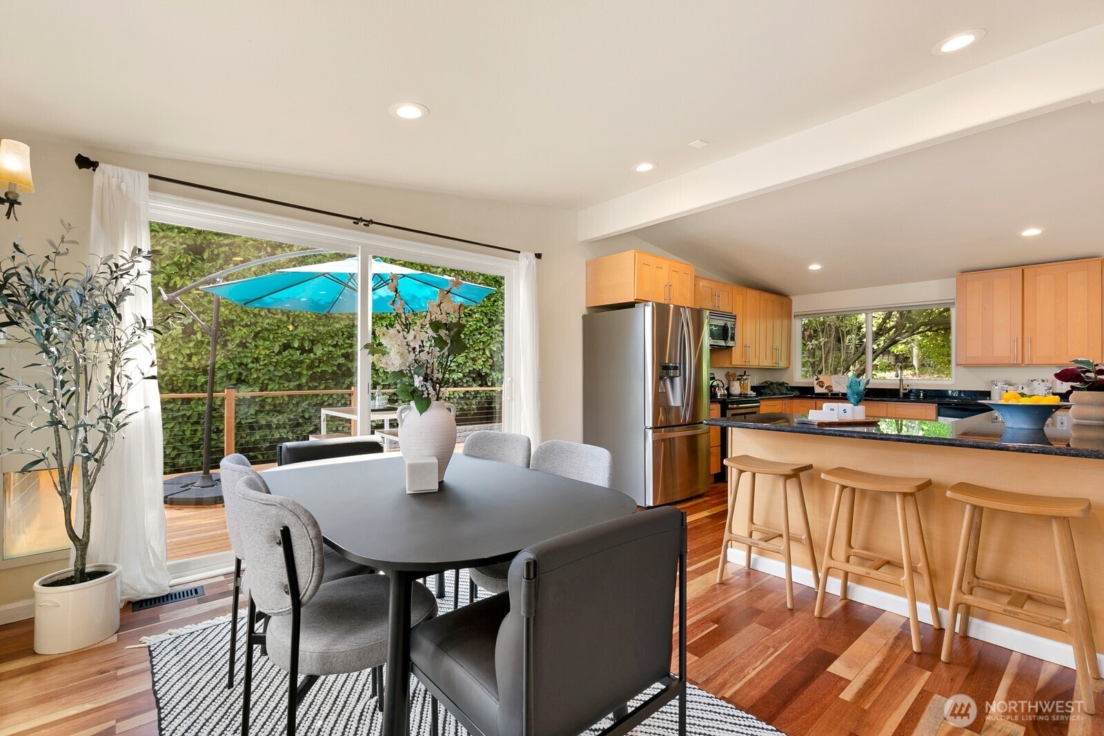 3701 Southwest Southern Street Seattle, WA 98126 - Photo 10 of 33 a kitchen with stainless steel appliances granite countertop a table chairs and a refrigerator