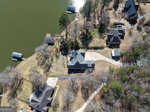 an aerial view of a house with a yard
