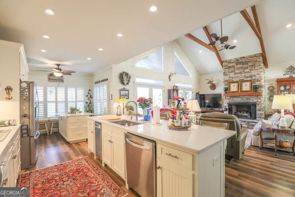 a kitchen with stainless steel appliances kitchen island granite countertop a stove and cabinets