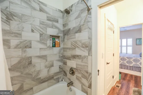 a bathroom with a bathtub and shower