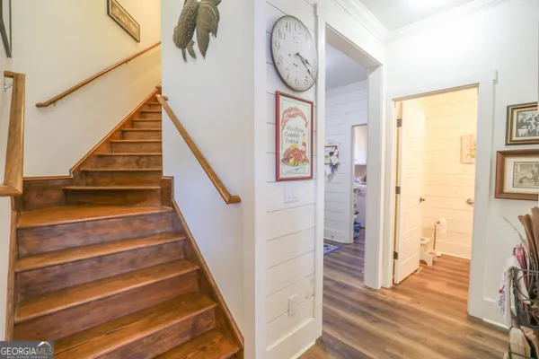 a view of entryway and hall with wooden floor