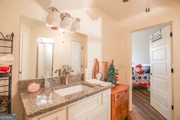 a room with kitchen island granite countertop a white cabinets and potted plant