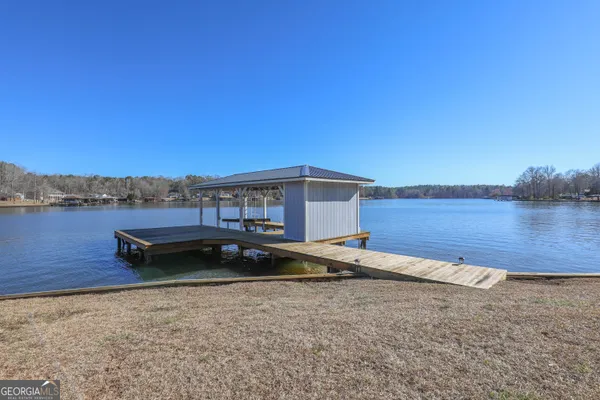 a view of a lake with wooden fence