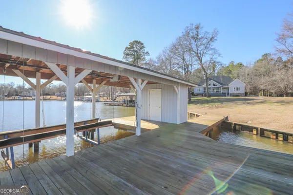 a porch with seating space and yard in the back