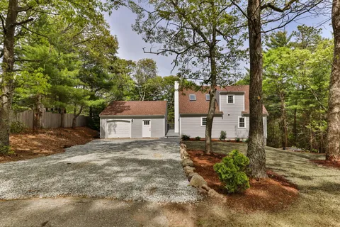 front view of a house with a tree