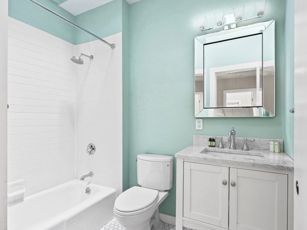 50 Roberts Road Cambridge, MA 02138 - Photo 12 of 25 a bathroom with a toilet sink vanity and mirror