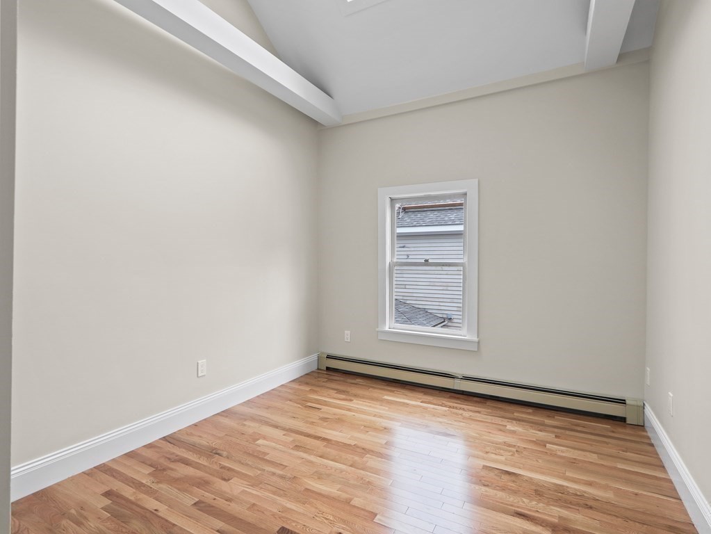 50 Roberts Road Cambridge, MA 02138 - Photo 15 of 25 a view of an empty room with wooden floor and a window